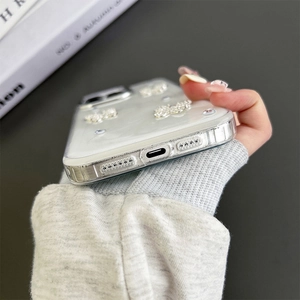 Detail of silver butterfly phone case showing precise charging port cutouts and 3D rhinestones
