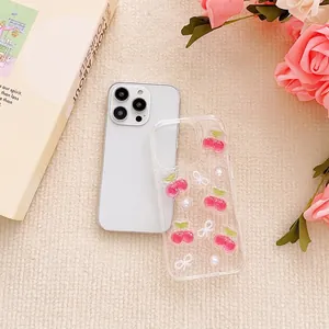 Clear iPhone case with 3D pink cherry and pearl bow charms on beige knit background