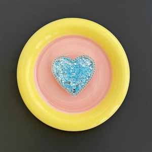Macro detail of blue glitter heart phone socket with sparkling rhinestones border