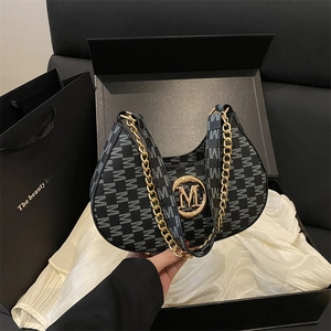 Fashionable black monogram underarm bag with gold M buckle and chain in a gift box