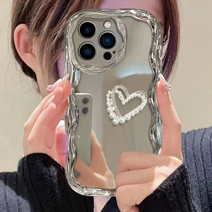 Mirror finish iPhone case with silver wavy edges and a white pearl heart design