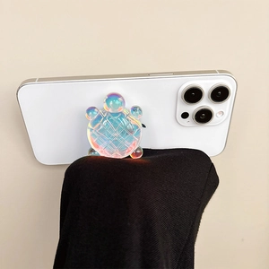 Creative 3D turtle phone grip with holographic aurora finish on a white smartphone