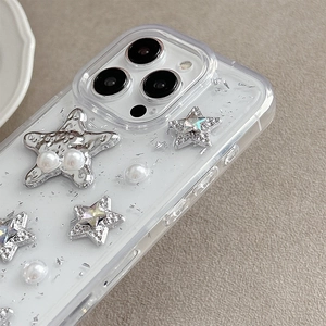 Detail of glitter silver foil phone case with pearls and shiny rhinestone stars for iPhone
