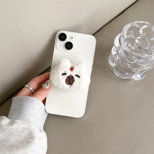 Close-up of a cute white plush capybara phone grip with soft fur and embroidered face