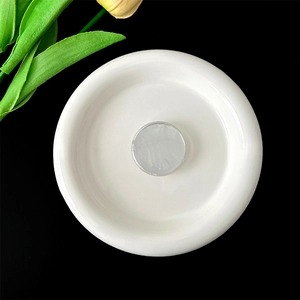 Top view of minimalist white ceramic phone grip holder with silver metallic center detail