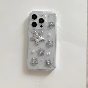 Detail of transparent iPhone case with silver foil flakes, pearl beads and 3D stars