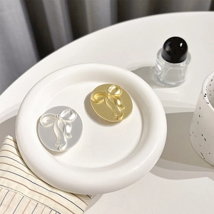 Metallic oval bowknot phone socket stand in gold and silver finish for desktop