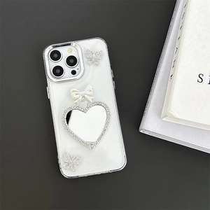 Detail of iPhone case featuring rhinestone butterflies, a bow, and a heart mirror surface