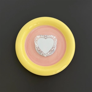 Macro shot of glittery heart-shaped MagSafe phone stand with mirror and Gift For You text
