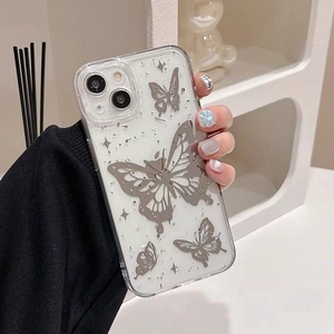 Detail of silver butterfly and glitter decorations on transparent iPhone case