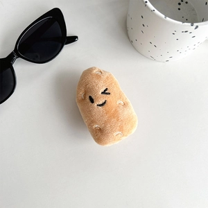 Close-up of cute potato plush phone socket with soft texture and winking embroidery