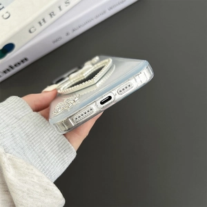Detailed close-up of iPhone case with rhinestone butterfly and heart mirror stand
