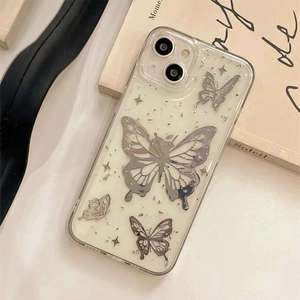 Detail of clear iPhone case featuring silver mirror butterfly patterns and glitter accents