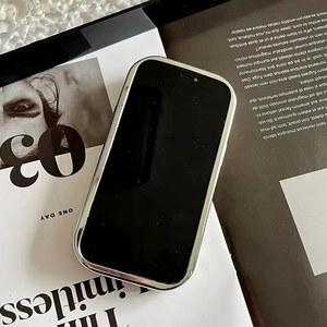 Close-up of a silver electroplated iPhone case with sleek black finish on a fashion magazine