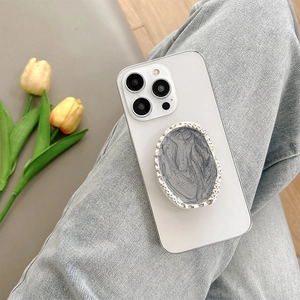 Silver marble phone socket grip on white smartphone with metal textured border details