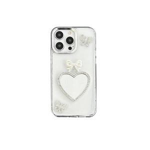 Glitter iPhone case with rhinestone heart and pearl bow design on clear background