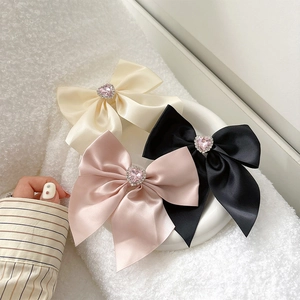 Sparkling rhinestone bow phone grip with pink heart gem in white black and pink