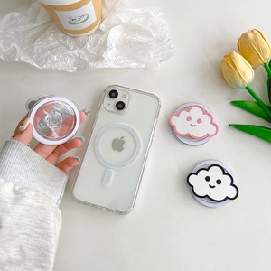 Close-up of MagSafe cloud phone grip and transparent case with tulips on white desk