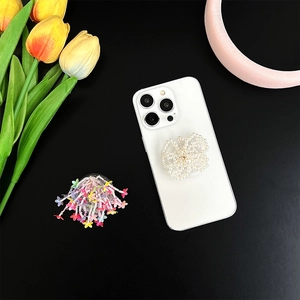 Beaded butterfly and floral phone grip holder with pearls on a black background