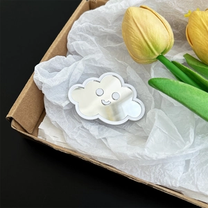 Detailed view of a cute cloud-shaped mirror phone stand featuring a smiley face