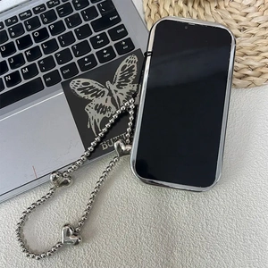 Detailed view of a stylish silver mirror phone case featuring a chic heart bead strap lanyard