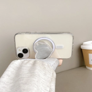 Detail of heart-shaped rhinestone phone grip mirror on a clear MagSafe iPhone case