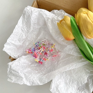 Detailed close-up of colorful flower bead phone grip with pearl string in a gift box