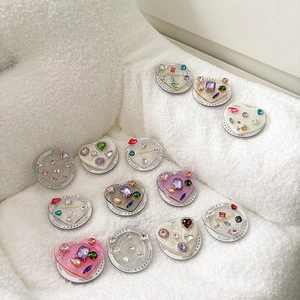 Colorful rhinestone heart and round phone grips on soft white sherpa background