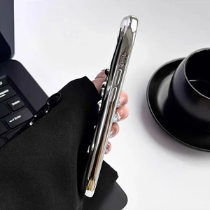 Silver plated puppy heart iPhone case with luxury hand chain on a professional business desk
