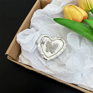 Detailed view of silver heart phone socket featuring a sparkly rhinestone butterfly