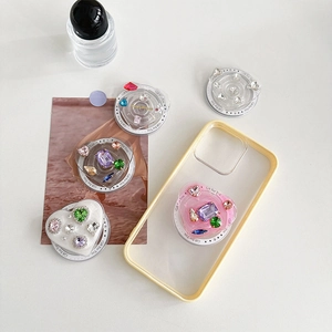 Close-up of colorful gemstone heart phone grip with Magsafe magnet on desktop