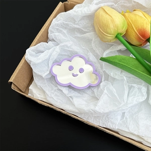 Close-up detail of the cute purple cloud mirror phone stand in gift packaging boxes