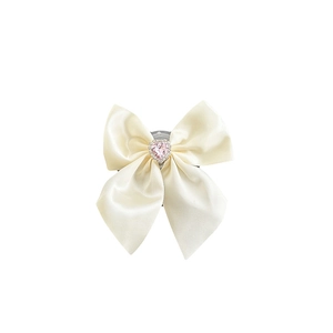 Cream satin bow phone socket with a pink heart rhinestone center for mobile devices
