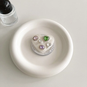 Close-up of heart phone grip with colorful rhinestones on a white ceramic plate