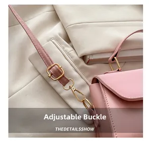 Detail of pink leather handbag showing adjustable golden buckle and metal hardware