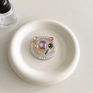 Detail of heart-shaped phone grip with multi-colored gemstones and Gift For You text
