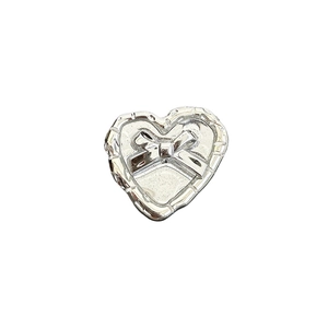 Silver heart-shaped phone socket grip with elegant bow design on white background