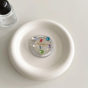 Detail of heart-shaped phone grip with colorful gemstones and Diamonds lettering