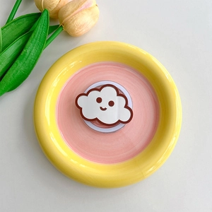 Cute cloud phone grip with smile face on a yellow and pink tray with tulips decoration