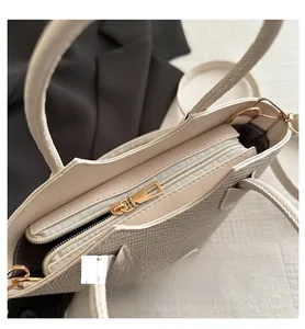 Detailed view of the smooth golden zipper closure and woven texture of the bucket bag