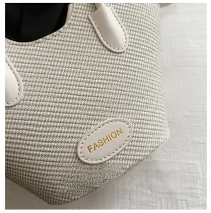 Close-up of woven bucket bag with fashion leather patch and high-density knit texture