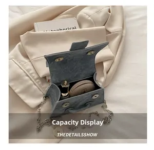 Internal capacity display of the blue denim mini bag with lipstick and compact powder