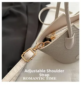 Detail of adjustable shoulder strap and woven texture on beige bucket tote bag