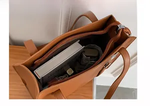 Internal view of caramel brown tote bag showing large capacity main pocket and zipper pouch