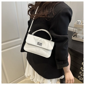 Detail view of the white crossbody square bag with a silver metallic twist lock closure