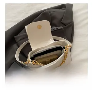 Spacious interior of white leather baguette bag showing room for phone and wallet