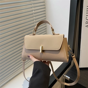Chic beige minimalist handbag with gold cylindrical lock and detachable shoulder strap