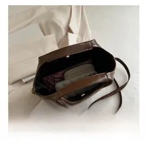 Internal view of brown handbag showing storage capacity for phone and wallet