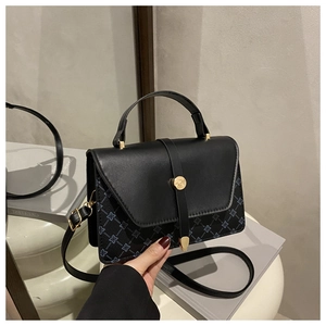 Detail of vintage navy jacquard pattern and premium leather flap with gold hardware