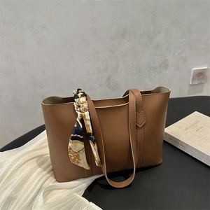 Minimalist brown leather tote bag with printed silk scarf detail and large capacity